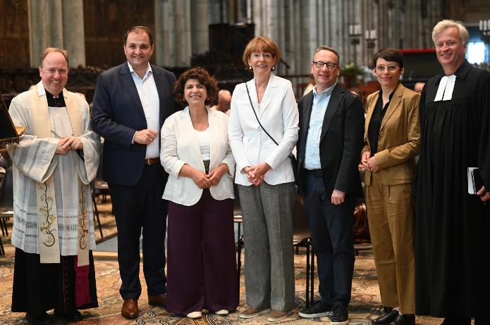 Von links: Stadtdechant Msgr. Robert Kleine, NRW-Minister Natanael Liminski, Landtagsvizepräsidentin Berîvan Aymaz, Oberbürgermeisterin Henriette Reker, Landtagsvizepräsident Christof Rasche, NRW-Ministerin Josefine Paul, stellvertretender Stadtsuperintendent Markus Zimmermann. Foto: © Beatrice Tomasetti